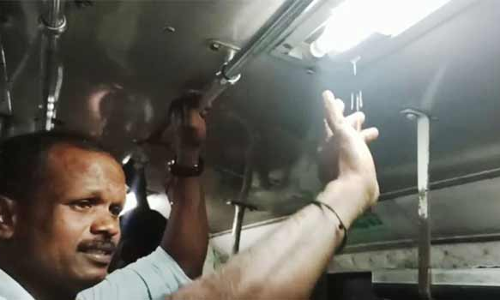பஸ்சுக்குள் குடைபிடித்து பயணித்த பொதுமக்கள்