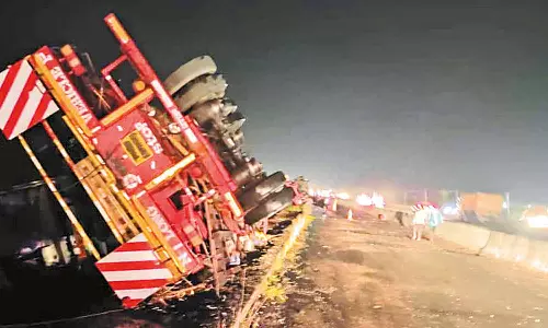 சூறாவளி காற்று வீசியதால் காற்றாலை இறக்கைகளுடன் பள்ளத்தில் கவிழ்ந்த லாரிகள்