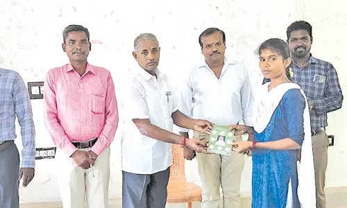 மாணவர்களை புத்தகம் கொடுத்து வரவேற்ற கல்லூரி முதல்வர்