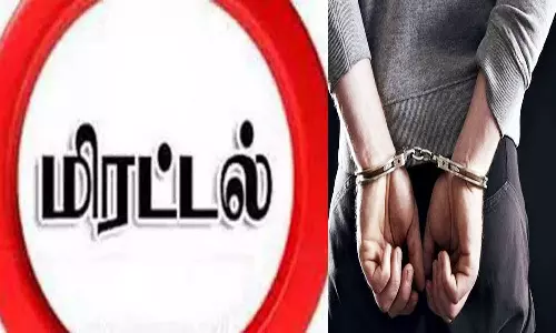 கணவன், மனைவியை மிரட்டிய 2 பேர் கைது