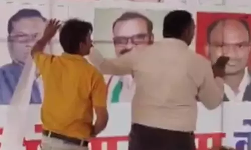 ராகுல் காந்தி பொதுக்கூட்ட மேடையில் பா.ஜனதா வேட்பாளர் படம்