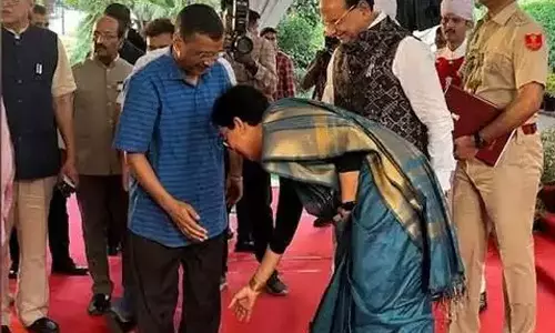 Atishi touches Kejriwals feet after taking oath as Delhi CM