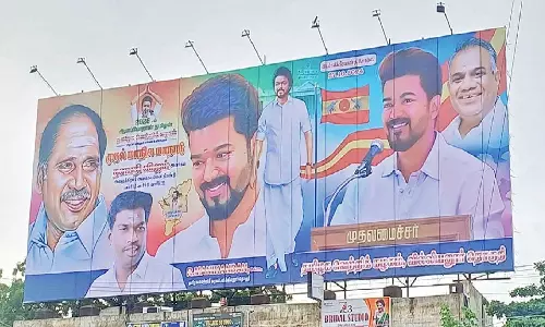 புதுச்சேரியில் முதல்-அமைச்சர் ரங்கசாமி படத்துடன் விஜய் கட்சி மாநாட்டு பேனர்