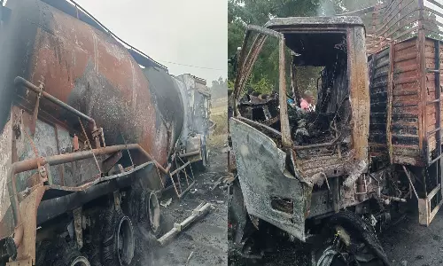 2 லாரிகள் நேருக்கு நேர் மோதி தீ பிடித்தது- டிரைவர் கருகி பலி